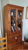 Full view of china cabinet showing glass doors, drawer, lower doors