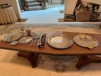 Overall view of all silverplate pieces arranged on table
