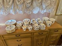 Full lot on sideboard showing plates, bowls, cups and serveware