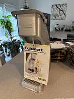 Front view of Cuisinart beverage maker with manual attached