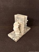 Left side view of pair showing owl carving and marble pattern