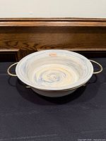 Bowl resting in brass stand, full view