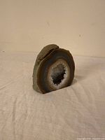 Front view showing polished agate bands and druzy centre
