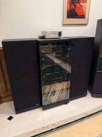 Full view of cabinet between both Sharp floor speakers