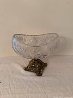 front view of cut crystal bowl on ornate brass-tone base