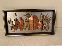Overall view of framed copper & brass brutalist wall art signed Yona