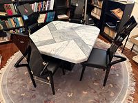 Full dining set showing table and three chairs, illustrates overall design