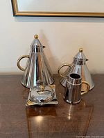 Full set showing two teapots, sugar bowl with lid on square base, and creamer jug