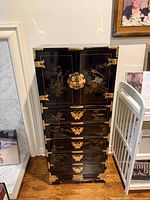 Front view showing entire chest, brass hardware, painted decoration