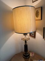 Full view of lamp lit with drum shade