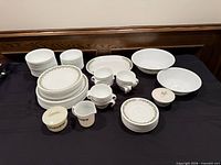 Full view of stacked dinnerware showing plates, bowls, cups, and serve pieces