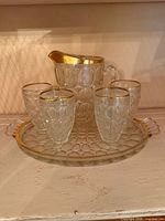 Complete set showing pitcher, four tumblers, and tray