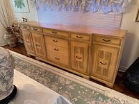 Full view of light wood sideboard, doors and drawers visible