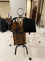 Front view of metal butler valet stand showing overall design and platforms