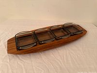 top view of wooden tray with four glass dishes inserted