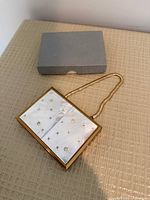 Closed compact with handle and storage box
