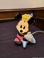 Front view of illuminated ceramic Minnie Mouse lamp