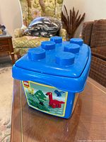Blue LEGO Duplo storage bin with lid, front view