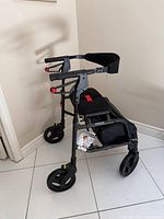 Full view of rollator showing seat, backrest and storage bag