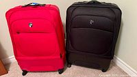 Front view of red and black Heys Stratos Hybrid suitcases