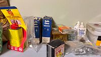 Left side hardware including Goof Off can, nail boxes, Loctite bottles, plastic fastener boxes