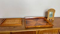 Overview of two trays and picture frame on sideboard
