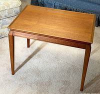 Full view of teak side table showing legs and top