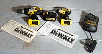 Full lot: drill, impact driver, battery, charger, manuals visible