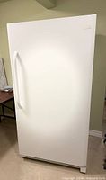 Full front view of white Frigidaire upright refrigerator