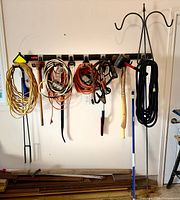 Overall view of cords, tools, and hanger on wall