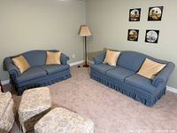 Sofa and loveseat set in room with cushions visible