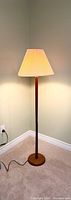 Full view of teak floor lamp with shade