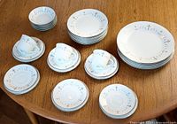Overview of entire 31-piece Dubarry dinnerware set arranged on table