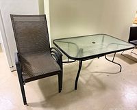 Table and one chair showing size, style, and materials