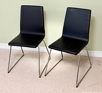 Two black IKEA LILLANÄS chairs side by side