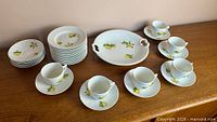 Overview of lemon motif plates, cups, saucers and handled platter