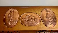 All three copper plaques displayed together