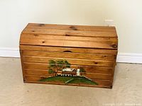 Front view of pine chest with painted farm scene
