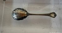 Full view of spoon front showing handle and bowl ornamentation
