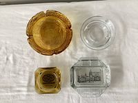 Top view of four ashtrays showing shapes, colors and graphics