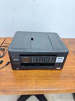 Top view of Brother MFC-J4970W printer with cables visible