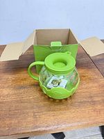 Popcorn popper with lid beside opened original box