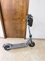 Full side view of gray Gotrax scooter folded upright