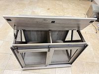 Bench top lifted showing divided interior compartments