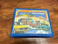 Closed blue Matchbox carry case with illustrated lid