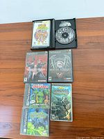 All seven game cases and disc laid out on table