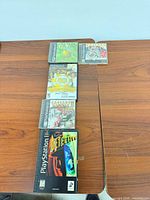 Five PlayStation game cases laid vertically on table