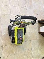 Top view of Ryobi 2300 PSI brushless electric pressure washer showing handle, nozzles and body