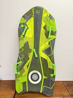 Front view of neon green/gray Sno-Storm Vipernex sled showing handles and tow rope