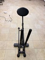 Top view of complete trainer showing seat, handles, rail base and wheels